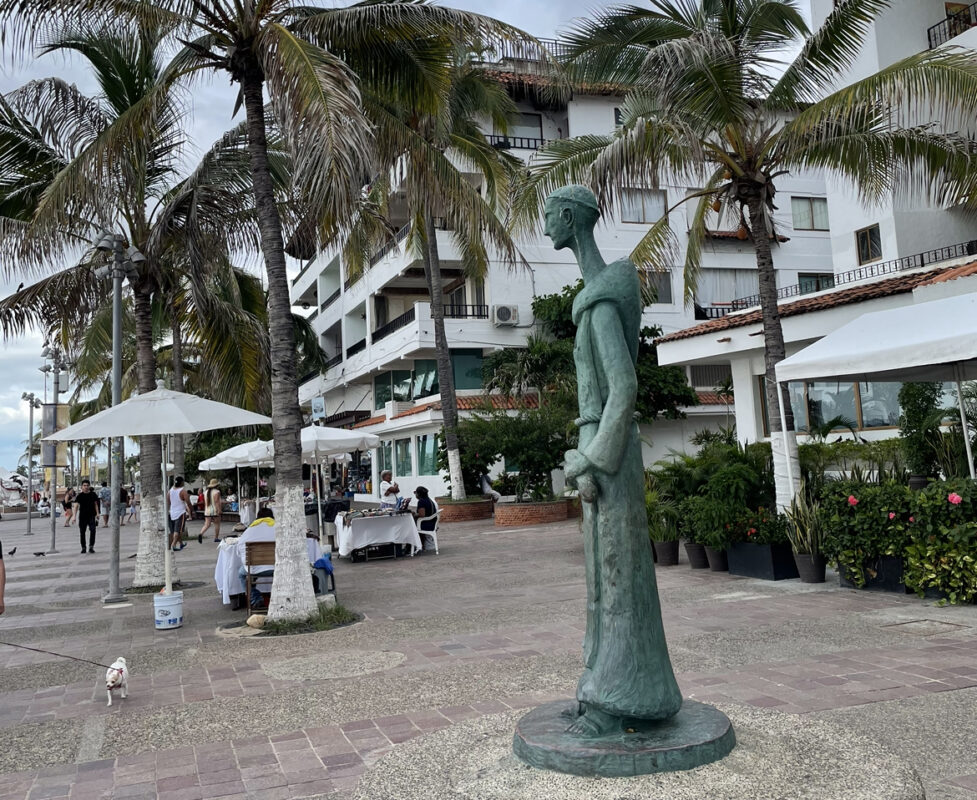 A statue of a monk standing alone an