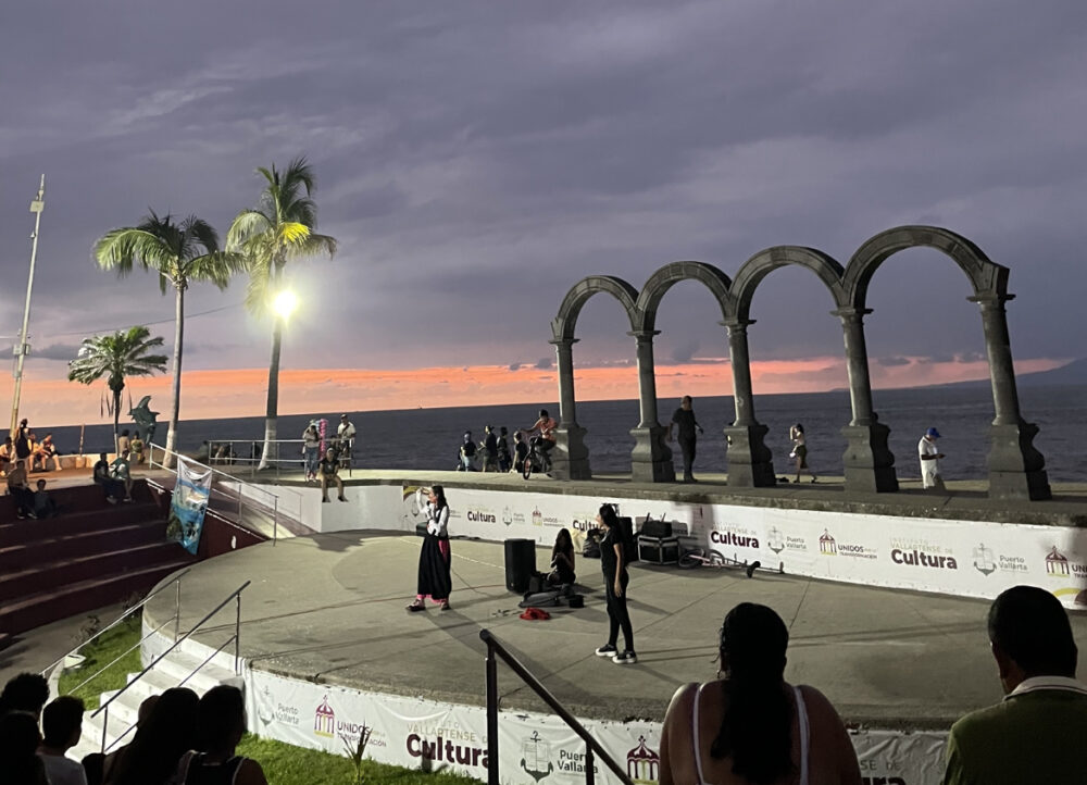 A sculpture of four arches at sunset. 